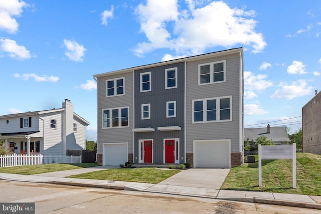 view of front of property featuring central AC, a garage, and a front lawn