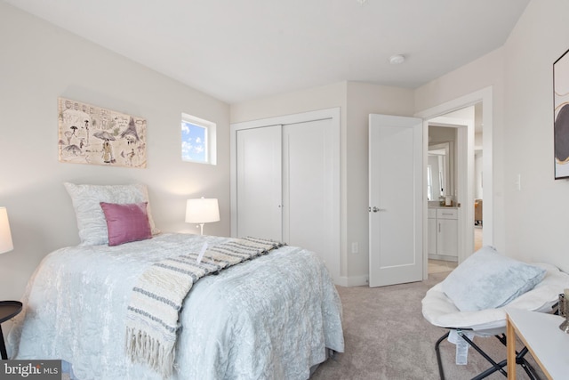 bedroom featuring light colored carpet and a closet