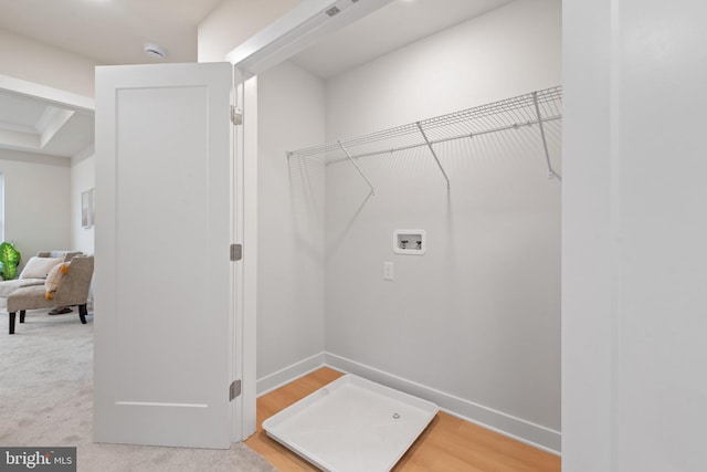 laundry room featuring hookup for a washing machine and light hardwood / wood-style flooring