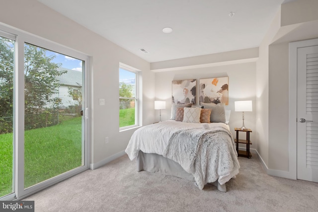 bedroom with light carpet and access to outside