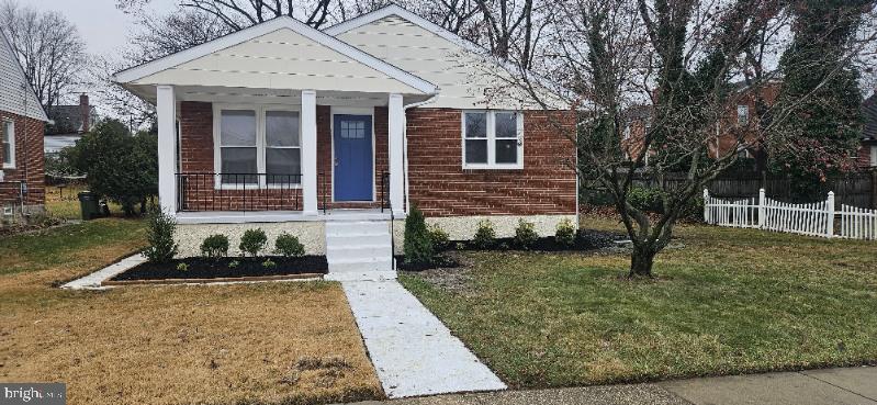 bungalow-style home with a front yard