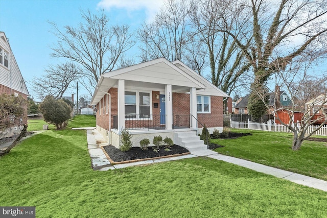 bungalow with covered porch and a front yard