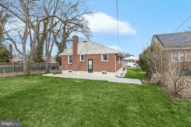 rear view of house featuring a yard and a patio