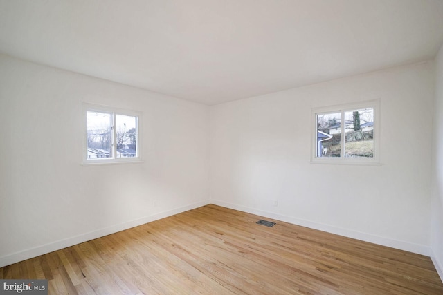 empty room with a healthy amount of sunlight and light wood-type flooring