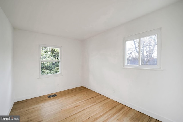 unfurnished room with hardwood / wood-style floors