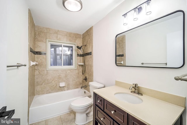 full bathroom featuring tiled shower / bath combo, vanity, tile patterned floors, and toilet