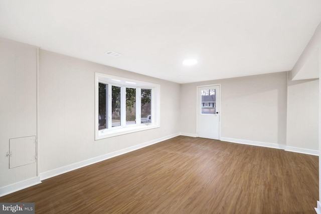 spare room with dark hardwood / wood-style flooring