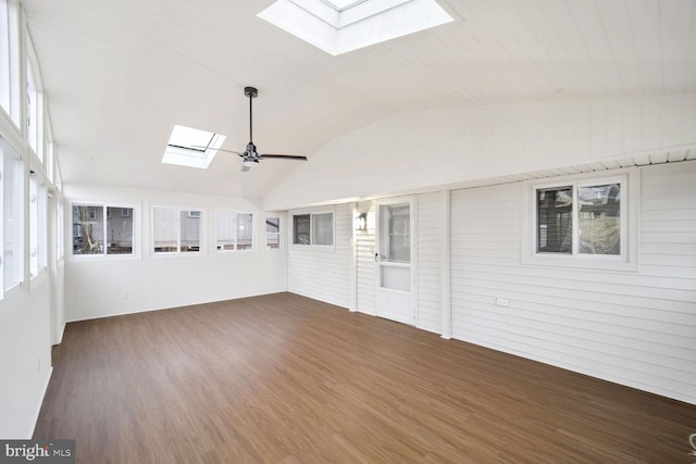 unfurnished sunroom featuring ceiling fan and vaulted ceiling with skylight