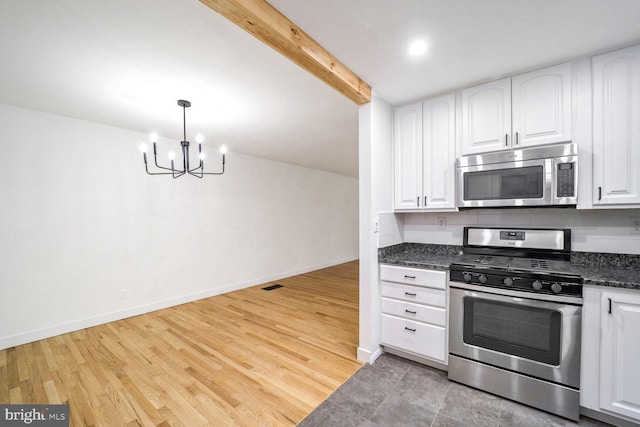 kitchen featuring pendant lighting, white cabinetry, and stainless steel appliances