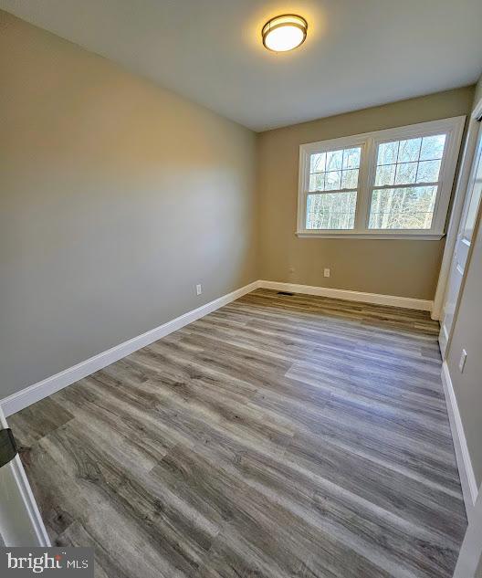 unfurnished room featuring wood-type flooring