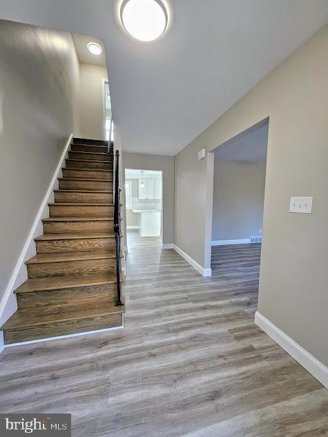 stairway featuring hardwood / wood-style flooring