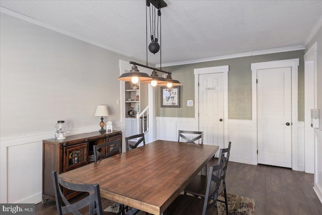 dining area with crown molding, dark hardwood / wood-style floors, and a textured ceiling