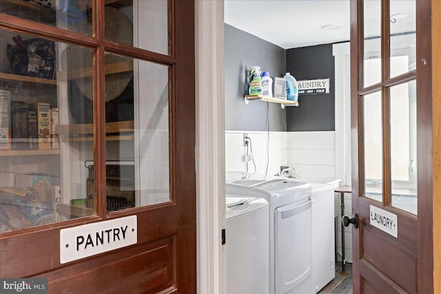 washroom featuring washer and clothes dryer