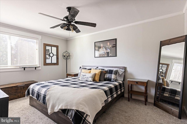 bedroom with crown molding, ceiling fan, and carpet flooring