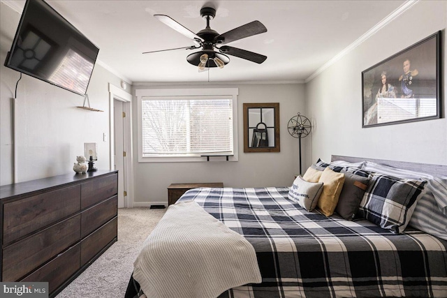 carpeted bedroom featuring crown molding and ceiling fan