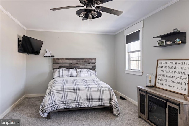 carpeted bedroom with ornamental molding and ceiling fan