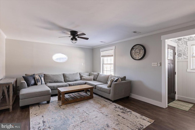 living room with dark wood-type flooring, ornamental molding, and ceiling fan