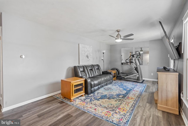 living room featuring hardwood / wood-style floors and ceiling fan