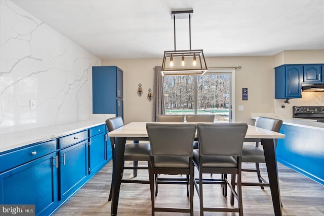 dining space with light hardwood / wood-style floors