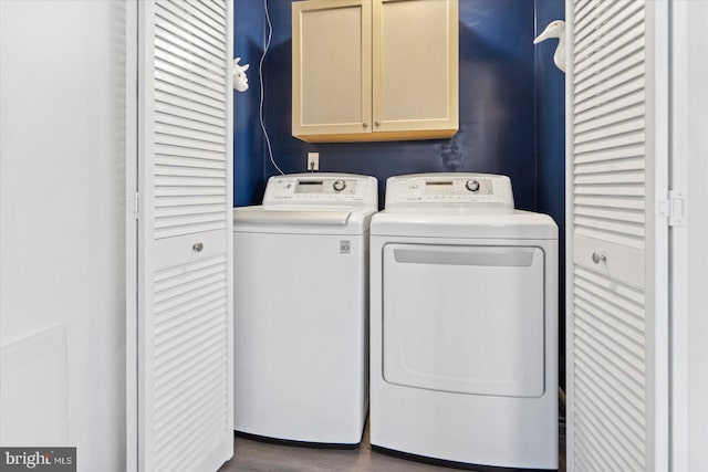 washroom with cabinets and washing machine and clothes dryer