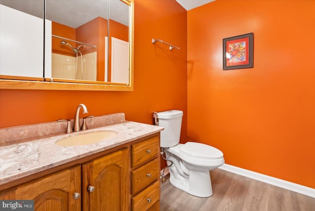 bathroom with vanity, a shower, wood-type flooring, and toilet