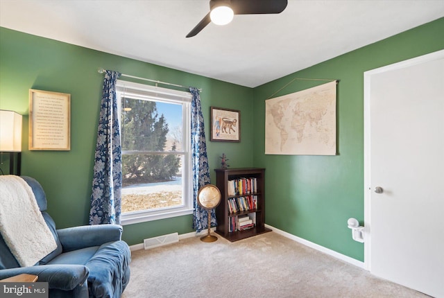 sitting room featuring ceiling fan, carpet floors, and a healthy amount of sunlight