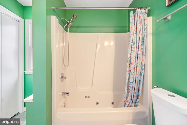 bathroom with shower / bathtub combination with curtain and toilet