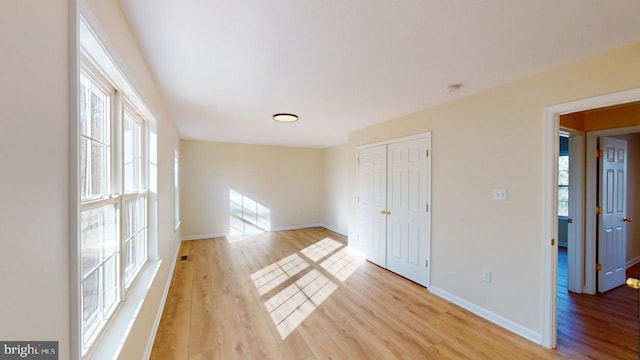 spare room with light hardwood / wood-style flooring