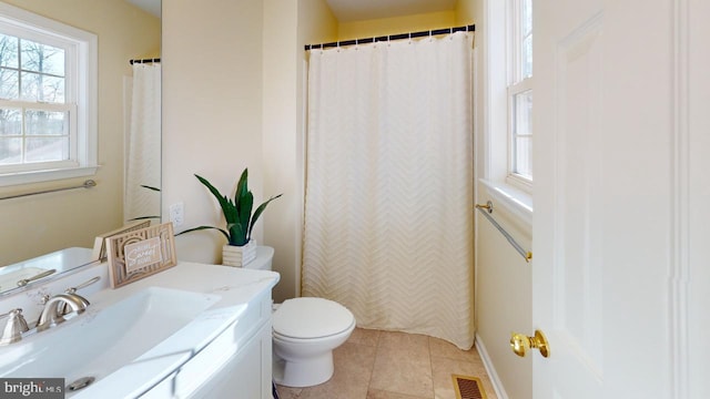 bathroom featuring tile patterned floors, toilet, and vanity