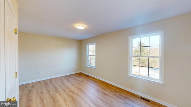 spare room featuring light hardwood / wood-style floors