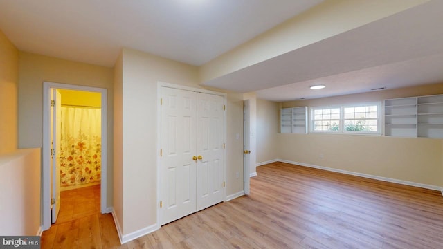 bedroom featuring light hardwood / wood-style floors and a closet