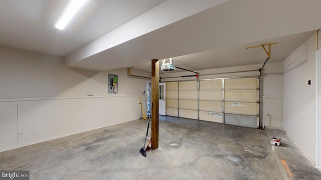 garage with a garage door opener and electric panel