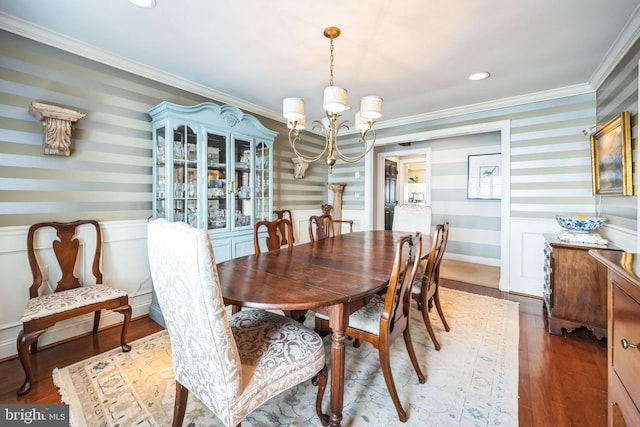 dining area featuring ornamental molding, hardwood / wood-style floors, and a chandelier