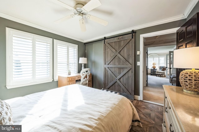 bedroom featuring dark parquet floors, ornamental molding, ceiling fan, a barn door, and a closet