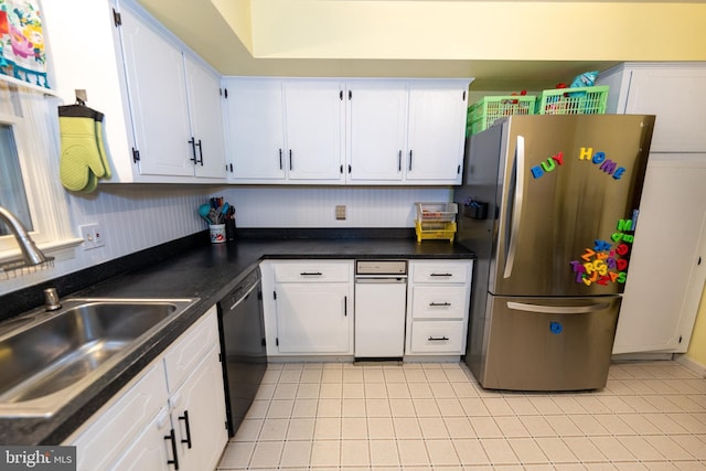 kitchen with sink, light tile patterned floors, stainless steel refrigerator, dishwasher, and white cabinetry