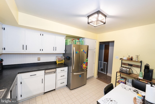 kitchen with stainless steel fridge, white cabinets, and light tile patterned flooring