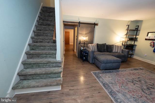 living room with dark hardwood / wood-style floors and a barn door