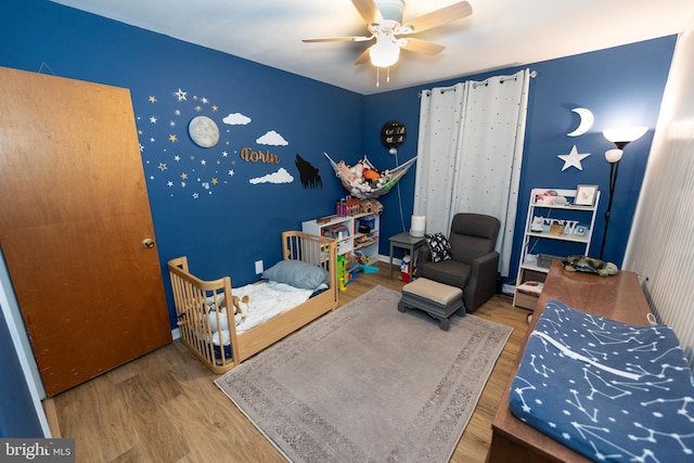 bedroom featuring hardwood / wood-style flooring and ceiling fan