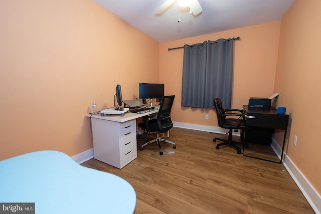 office space with light hardwood / wood-style floors and ceiling fan