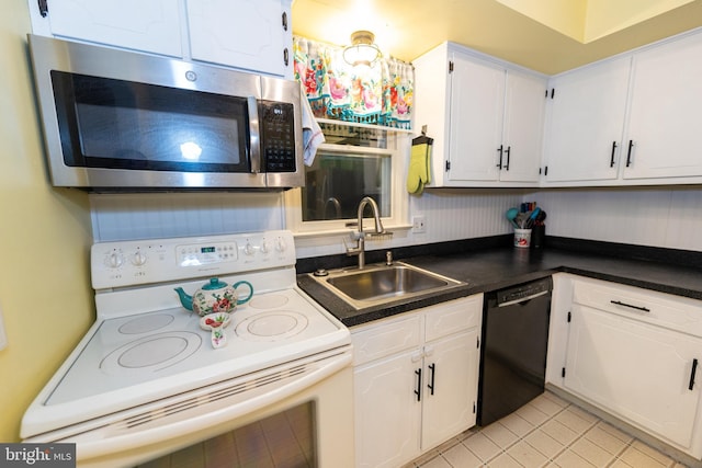 kitchen featuring black dishwasher, sink, white cabinets, light tile patterned floors, and white range with electric cooktop