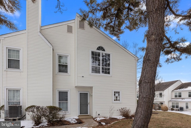 view of front of property featuring central AC unit and a front lawn