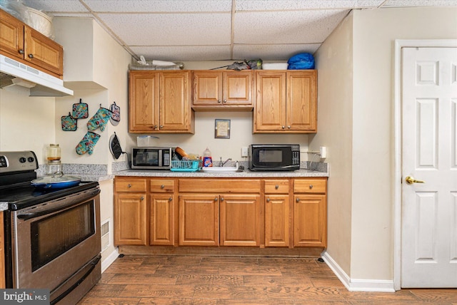 kitchen featuring dark hardwood / wood-style flooring, a paneled ceiling, and appliances with stainless steel finishes