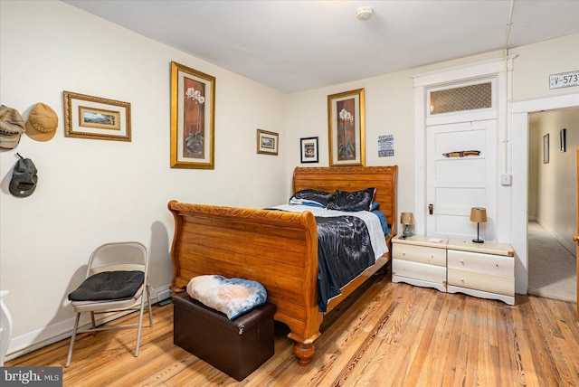 bedroom with wood-type flooring