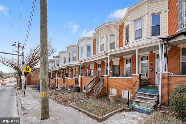 townhome / multi-family property featuring covered porch