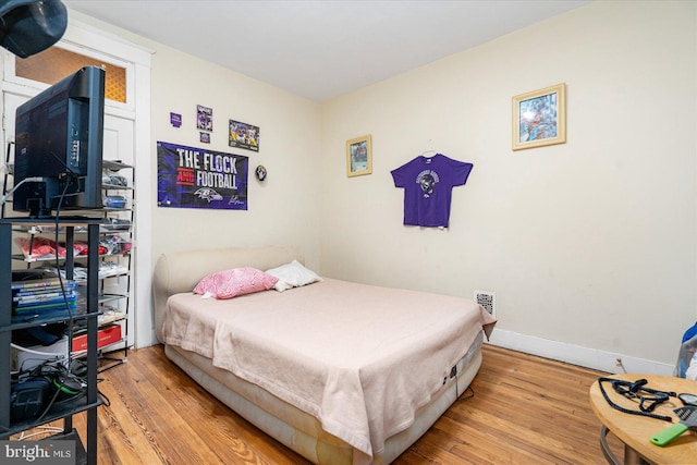 bedroom with light wood-type flooring