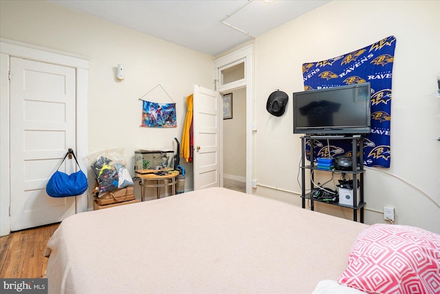 bedroom with wood-type flooring