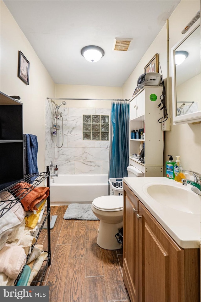 full bathroom with shower / bath combination with curtain, wood-type flooring, toilet, and vanity