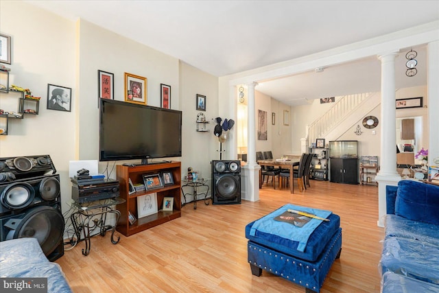 living room featuring ornate columns and light hardwood / wood-style flooring