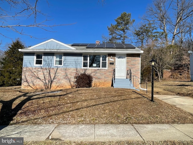 view of front of property featuring solar panels