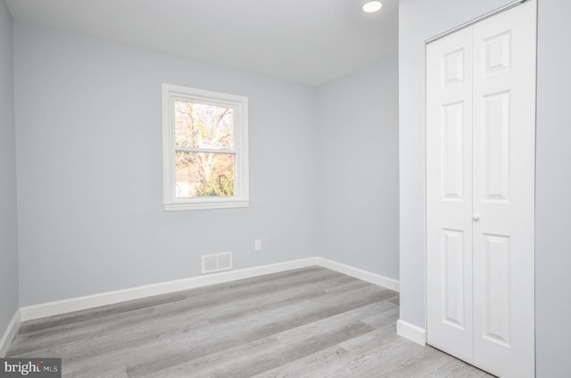 spare room featuring light wood-type flooring